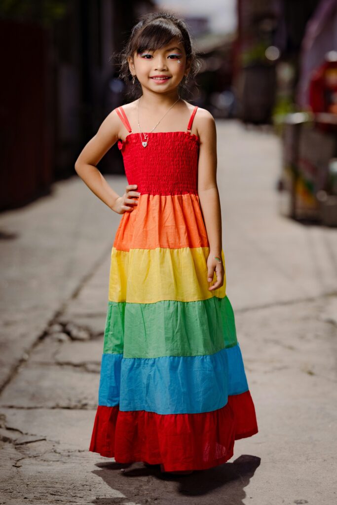 Kid in rainbow model dress
