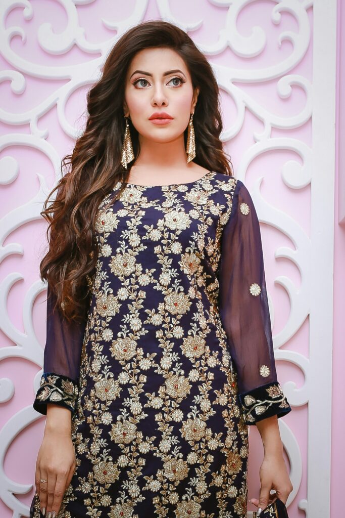 women in blue top with designs