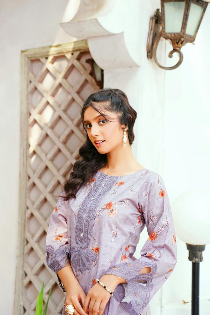 Gorgeous women posing in violet kameez